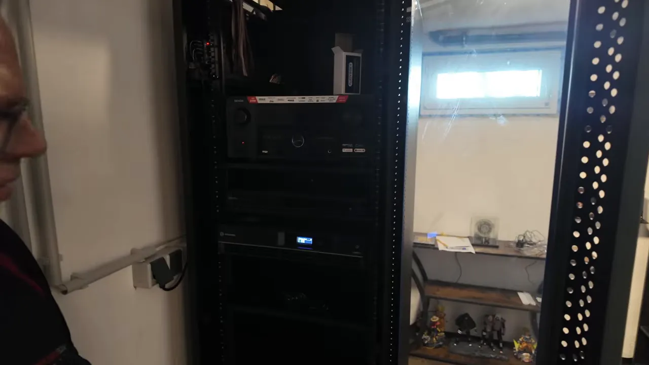 Schwarzes Serverrack mit AV-Receiver, Blu-ray-Player und weiteren Heimkino-Komponenten