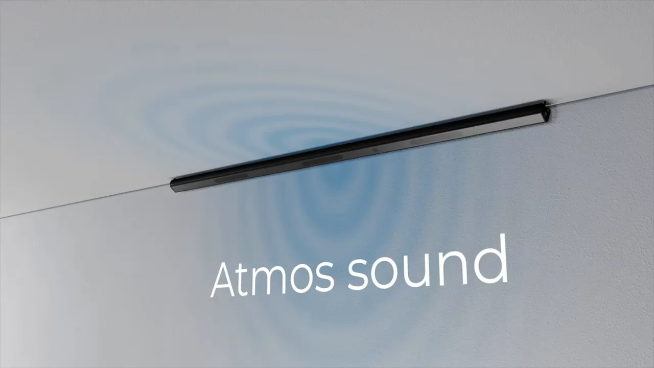 Schmaler schwarzer Lautsprecher hoch in einer Raumecke mit eingeblendeter Beschriftung Atmos sound